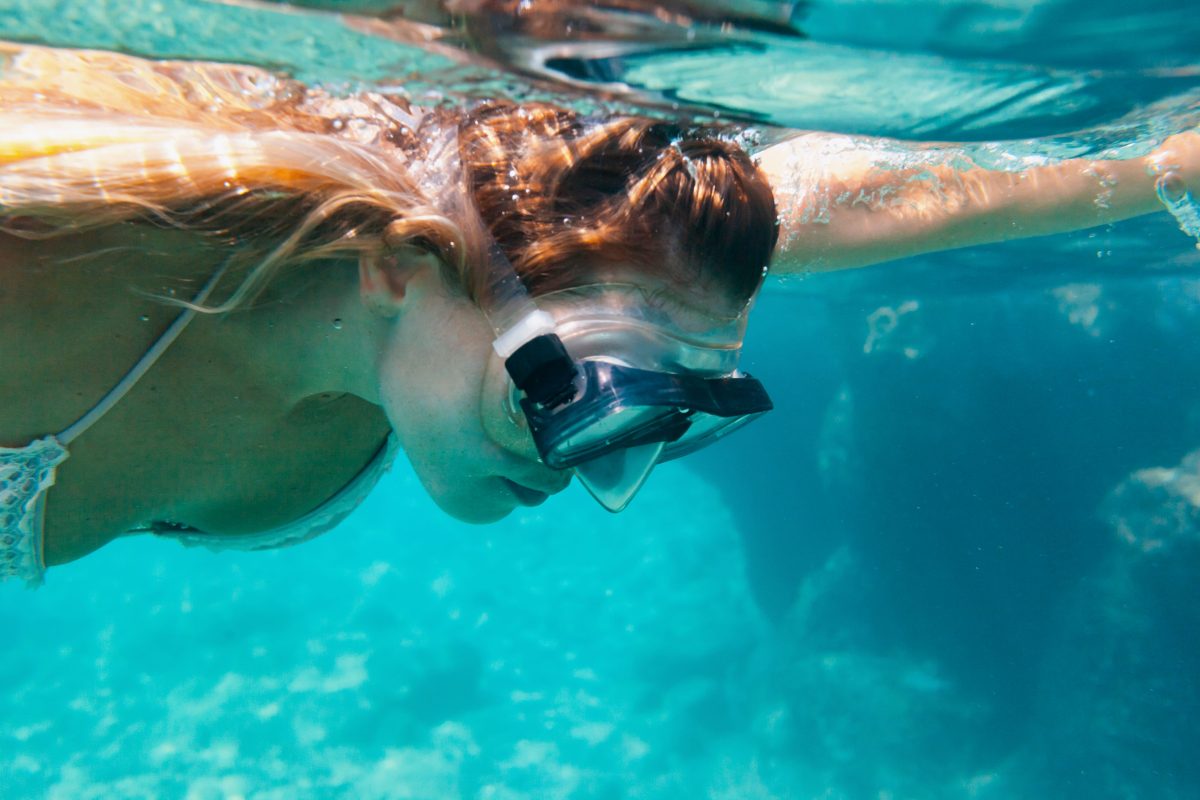 young-woman-snorkeling-underwater swimming in the waters of Diaporos Island