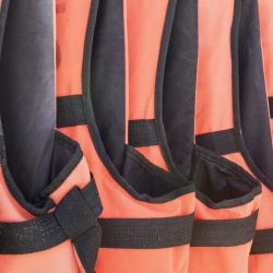 close-up-of-orange-life-jackets-in-a-row-2023-11-27-05-03-23-utc